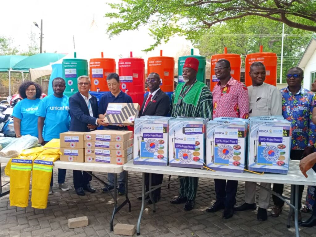 Upper East Regional Director of the Ghana Health Service receiving the items from KOICA and UNICEF officials.