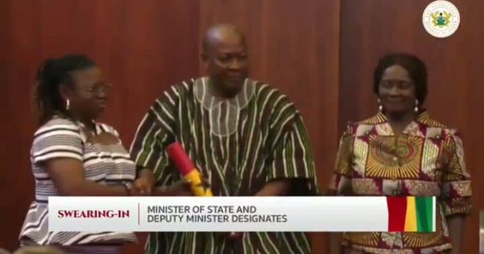 President Mahama hands Lydia Akanvariba the instrument of office